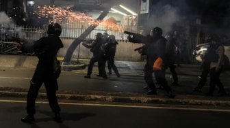 Petugas menembakan gas air mata saat membubarkan massa yang masih bertahan di depan kantor Bawaslu di kawasan Thamrin, Jakarta, Selasa (21/5). [ANTARA FOTO/Muhammad Adimaja]