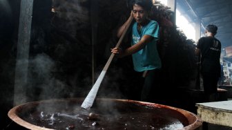 Pekerja membuat dodol Betawi di Kalibata, Jakarta, Jumat (24/5). [suara.com/Oke Atmaja]