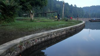 Wisatawan menikmati pemandangan Situ Gunung yang berada di Cisaat, Kabupaten Sukabumi, Jawa Barat, Sabtu (25/5). [Suara.com/Arief Hermawan P]
