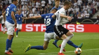 Pemain depan Jerman Marco Reus bersaing dengan gelandang Estonia Karol Mets untuk mendapatkan bola selama pertandingan sepak bola Grup C kualifikasi Euro 2020 Jerman melawan Estonia di Opel Arena, Mainz, Jerman, Rabu (12/6). dini hari WIB. [INA FASSBENDER / AFP]
