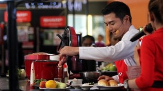 Artis Nicky Tirta bersama pengunjung memasak beberapa menu makanan saat sesi cooking class dalam acara "‘SHARP Indonesia 50 Years in Harmony’ Roadshow" di Mal Kelapa Gading 3, Jakarta, Sabtu (13/7). [Suara.com/Arief Hermawan P]