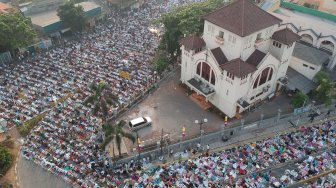 Umat Muslim menjalankan salat Idul Adha 1440 H di sekitar Gereja Koinonia, Jalan Matraman Raya, Jatinegara, Jakarta, Minggu (11/8). [Suara.com/Arya Manggala] 