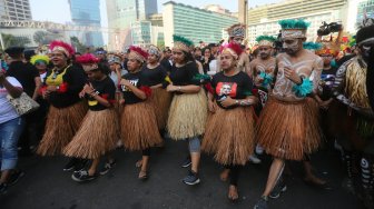 Masyarakat Papua di Jakarta menggelar acara Tari Yospan Papua di kawasan Car Free Day, Jakarta, Minggu (1/9). Acara tersebut merupakan bentuk dari perkenalan Budaya Papua kepada masyarakat luas sehingga dapat hidup berdampingan dan menjaga persatuan dan kesatuan Bangsa. [Suara.com/Arya Manggala] 
