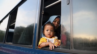 Sejumlah pengungsi tiba di Landasan Udara Halim Perdana Kusuma, Jakarta, Kamis (3/10). [Suara.com/Angga Budhiyanto]