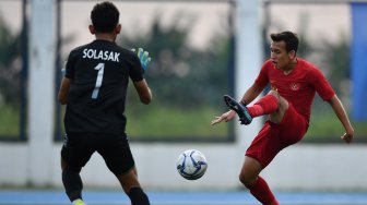 Pemain Timnas U-22 Indonesia Eggy Maulana Vikri (kanan) berhadapan dengan penjaga gawang Timnas Laos Solasak Thilavong dalam pertandingan Grup B SEA Games 2019 di Stadion City of Imus Grandstand, Filipina, Kamis (5/12). [ANTARA FOTO/Sigid Kurniawan]