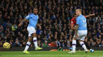 Striker Manchester United Anthony Martial menembak untuk mencetak gol  selama pertandingan sepak bola Liga Inggris antara Manchester City melawan Manchester United di Stadion Etihad, Manchester, Inggris, Sabtu (7/12). [Lindsey Parnaby / AFP]
