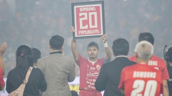 Pesepak bola Persija Jakarta Bambang Pamungkas (tengah) mengangkat kostum miliknya yang dibingkai usai melawan Persebaya Surabaya dalam lanjutan Liga 1 di Stadion Utama Gelora Bung Karno (GBK), Jakarta, Selasa (17/12).  [ANTARA FOTO/M Risyal Hidayat]