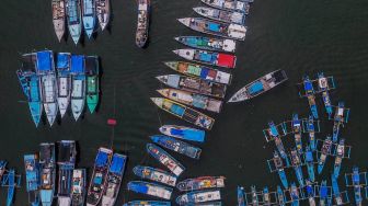 Foto udara sejumlah kapal nelayan bersandar di Pelabuhan Perikanan Cikidang, Kabupaten Pangandaran, Jawa Barat, Rabu (8/1). [ANTARA FOTO/Adeng Bustomi]