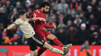 Penyerang  Liverpool Mohamed Salah menembak untuk mencetak gol kedua selama pertandingan sepak bola Liga Primer Inggris antara Liverpool melawan Manchester United di sStadion Anfield, Liverpool, Inggris, Minggu (19/1). [Paul ELLIS / AFP]