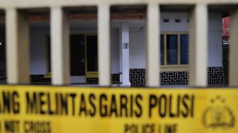 Garis polisi membentangi pagar klinik aborsi Paseban, Senen, Jakarta Pusat, Minggu (16/02). [Suara.com/Alfian Winanto]