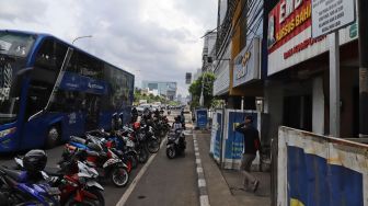 Rambu mengenai pemberlakuan parkir untuk kendaraan Ganjil-Genap di Jalan Gajah Mada, Jakarta Barat, Rabu (19/02). [Suara.com/Alfian Winanto]
