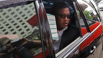 Sekjen PDIP Hasto Kristiyanto menunjukan sebuah buku saat meninggalkan Gedung KPK, Jakarta, Rabu (26/02). [Suara.com/Alfian Winanto]

