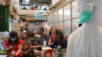 Aktivitas jual beli masker di Pasar Pramuka, Jakarta Timur, Senin (2/3). [Suara.com/Alfian Winanto]

