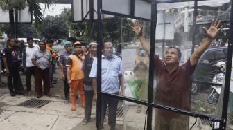 Sejumlah warga mengantre untuk menjajal alat Disinfection Chamber di kawasan Blok M, Jakarta Selatan, Selasa (24/3). [Suara.com/Angga Budhiyanto]