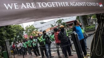 Pengemudi ojek online antre makanan gratis di kawasan Menteng, Jakarta, Jumat (3/4).  [ANTARA FOTO/Aprillio Akbar]
