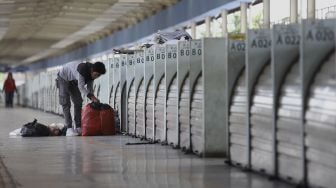 Pedagang merapikan dagangannya di Skybridge atau Jembatan Penyeberangan Multiguna (JPM) Tanah Abang di Jakarta, Senin (6/4). [Suara.com/Angga Budhiyanto]