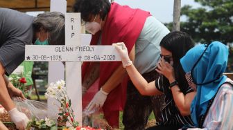 Mutia Ayu saat berziarah di makam musisi Glenn Fredly di TPU Tanah Kusir, Jakarta Selatan, Minggu (12/4). [Suara.com/Alfian Winanto]