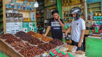 Pembeli memili kurma di Pasar Tanah Abang, Jakarta Pusat, Kamis (23/4). [Suara.com/Alfian Winanto]

