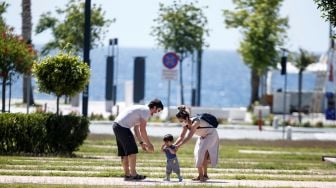 Orang tua menemani anaknya  bermain di taman setelah Turki mengizinkan anak-anak 14 tahun meninggalkan rumah  di Antalya, Turki pada 27 Mei 2020.  [Foto/Anadolu Agency]