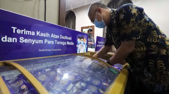 Pekerja saat merapikan tumpukan box eskrim Aice Susu telur yang akan diserahkan kepada rumah sakit rujukan Covid 19 di RS PGI Cikini, Jakarta Pusat, Jumat (26/6/20).  [Suara.com/Oke Atmaja]