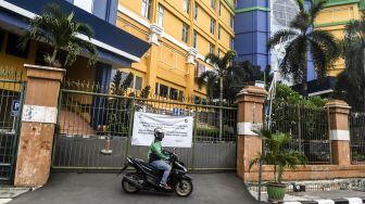 Pengendara ojek daring berada di depan pintu gerbang Pasar Glodok, Jakarta, Sabtu (4/7/2020). [ANTARA FOTO/Muhammad Adimaja]