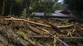 Warga berada di dekat rumah yang rusak berat akibat diterjang banjir bandang di Desa Oloboju, Kabupaten Sigi, Sulawesi Tengah, Sabtu (11/7). [ANTARA FOTO/Basri Marzuki]