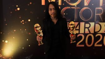 Aktor Muhammad Khan meraih penghargaan Pemeran Pendatang Baru Terbaik karena perannya di film 'Kucumbu Tubuh Indahku' dalam gelaran Indonesian Movies Actors Awards 2020 (IMAA) di Jakarta, Sabtu (25/7). [Suara.com/Alfian winanto]