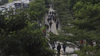 Sejumlah pekerja melintas di waktu pulang kerja di kawasan Sudirman, Jakarta, Kamis (6/8/2020). [Suara.com/Angga Budhiyanto]