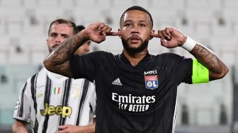 Penyerang Lyon Memphis Depay merayakan gol pertama timnya selama pertandingan sepak bola leg kedua babak 16 besar Liga Champions antara Juventus melawan Lyon di Allianz Stadium, Turin, Italia, Sabtu (8/8). dini hari WIB. [Miguel MEDINA / AFP]
