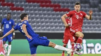 Bek Chelsea Andreas Christensen (kiri) bertarung memperebutkan bola dengan penyerang Bayern Munich Robert Lewandowski selama pertandingan  babak 16 besar Liga Champions UEFA antara FC Bayern Munich melawan Chelsea di Munich, Jerman, Sabtu (8/8/2020). [Tobias SCHWARZ / AFP]