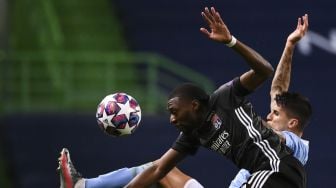 Penyerang Lyon Karl Toko Ekambi (kiri) bersaing dengan bek Manchester City Joao Cancelo selama pertandingan sepak bola perempat final Liga Champions UEFA antara Manchester City dan Lyon di stadion Jose Alvalade, Lisbon pada (15/8/2020). [FRANCK FIFE / AFP / POOL]