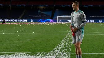 Kiper Bayern Munich, Manuel Neuer memotong gawang setelah pertandingan final Liga Champions antara Paris Saint-Germain melawan Bayern Munich di Luz stadium, Lisbon, Senin (24/8/2020) dini hari WIB. [LLUIS GENE / POOL]
