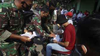 Personel TNI AD memberikan ganti rugi kepada warga sipil yang menjadi korban penyerangan Mapolsek Ciracas di Koramil 05 Kramat Jati, Jakarta, Rabu (2/9/2020). [Suara.com/Angga Budhiyanto] 