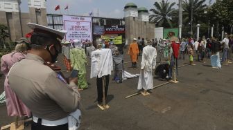 Puluhan boneka jerami atau orang-orangan sawah yang dipasang oleh massa Komite Nasional Pembaruan Agraria (KNPA) saat menggelar aksi Hari Tani Nasional  di depan gedung DPR RI, Jakarta, Kamis (24/9/2020). [Suara.com/Angga Budhiyanto]