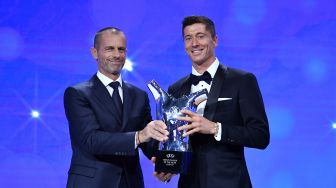 Penyerang Bayern Muenchen Robert Lewandowski saat menerima penghargaan pemain terbaik UEFA dalam acara UEFA Awards di Genewa, Swiss, Kamis (1/10). [Foto/AFP]