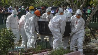 Petugas pemakaman membawa peti jenazah Bupati Bangka Tengah Ibnu Saleh untuk dimakamkan di TPU Jalan Muntok, Kota Pangkalpinang, Kepulauan Bangka Belitung, Minggu (4/10/2020). [ANTARA FOTO/Anindira Kintara]