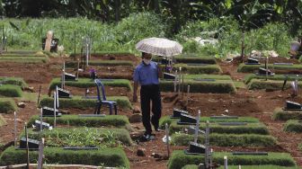 Warga berziarah ke makam keluarganya yang meninggal akibat COVID-19 di TPU Pondok Ranggon, Jakarta, Rabu (2/12/2020). [Suara.com/Angga Budhiyanto]