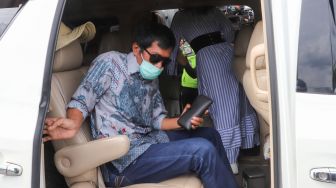 Komedian Kiwil bersama dengan istri mudanya, Eva Bellissima di dalam mobilnya saat ditemui di Terminal 2 Bandara Soekarno Hatta, Tangerang, Banten, Rabu (16/12). [Suara.com/Alfian Winanto]