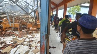 Sejumlah warga membantu menyelamatkan barang-barang pasca ambruknya atap ruang kelas SDN 1 Sukadana di Dusun Desa, Kabupaten Ciamis, Jawa Barat, Sabtu (2/1/2021). ANTARA FOTO/Adeng Bustomi