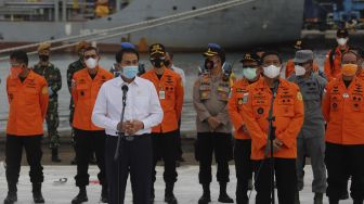 Wakil Ketua DPR Azis Syamsuddin (kiri) memberikan keterangan kepada awak media saat meninjau penanganan evakuasi pesawat Sriwijaya Air SJ 182 di Dermaga JICT, Tanjung Priok, Jakarta, Senin (11/1/2021). [Suara.com/Angga Budhiyanto]