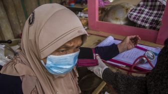 Relawan dari Yayasan KUN Humanity System memeriksa kesehatan warga yang terdampak banjir bandang di Desa Hantakan, Kabupaten Hulu Sungai Tengah, Kalimantan Selatan, Sabtu (23/1/2021). [ANTARA FOTO/Bayu Pratama S]