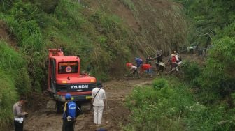 Sejumlah warga melintasi jalan yang tertutup tanah longsor di lereng Gunung Merapi, Cluntang, Musuk, Boyolali, Jawa Tengah, Selasa (26/1/2021). [ANTARA FOTO/Aloysius Jarot Nugroho]