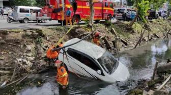 Pengemudi Hilang Kendali, Sebuah Mobil Terperosok ke Saluran Air di Jalan Darmawangsa