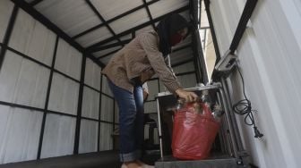 Petugas menimbang sampah anorganik di drop point rekosistem yang berada di Stasiun MRT Blok M, Jakarta, Jumat (5/3/2021). [Suara.com/Angga Budhiyanto]