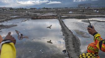 Sejumlah peserta melambaikan burung merpatinya pada Lomba Merpati Balap di Palu, Sulawesi Tengah, Minggu (14/3/2021). [ANTARA FOTO/Basri Marzuki]