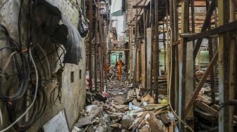 Pekerja menyelesaikan pembangunan rumah panggung di kawasan Kebon Pala, Jakarta, Rabu (7/4/2021).  ANTARA FOTO/Galih Pradipta