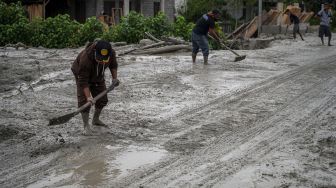 Sejumlah warga membersihkan jalan yang tertutup lumpur di Desa Beka, Marawola, Kabupaten Sigi, Sulawesi Tengah, Selasa (11/5/2021).  ANTARAFOTO/Basri Marzuki