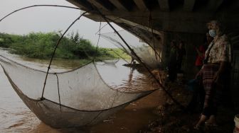 Menjaring Ikan di Bawah Kolong Tol Cibitung