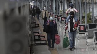 Sejumlah calon penumpang bersiap menaiki kereta di Stasiun Pasar Senen, Jakarta, Rabu (19/5/2021). [Suara.com/Angga Budhiyanto]