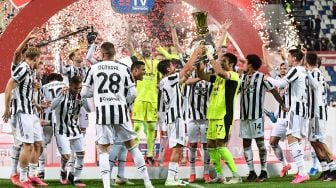 Kiper Juventus Gianluigi Buffon memegang trofi pemenang bersama para pemain Juventus saat merayakan kemenangan final pertandingan sepak bola Piala Italia (Coppa Italia) Atalanta melawan Juventus di Stadion Mapei, Reggio Emilia, Kamis (20/5/2021) dini hari WIB. Miguel MEDINA / AFP